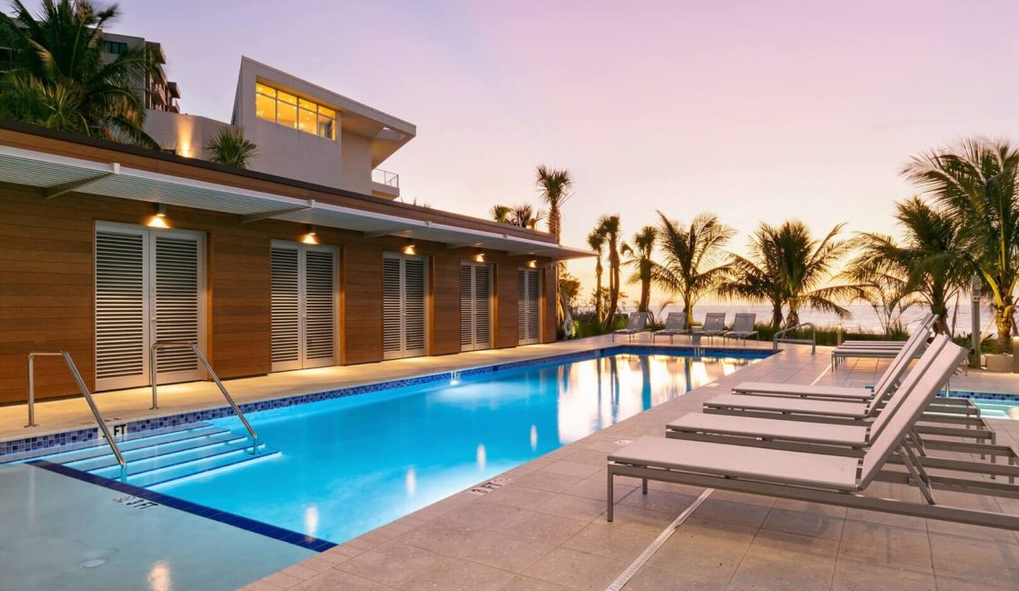 A pool with a lot of chairs and a bench