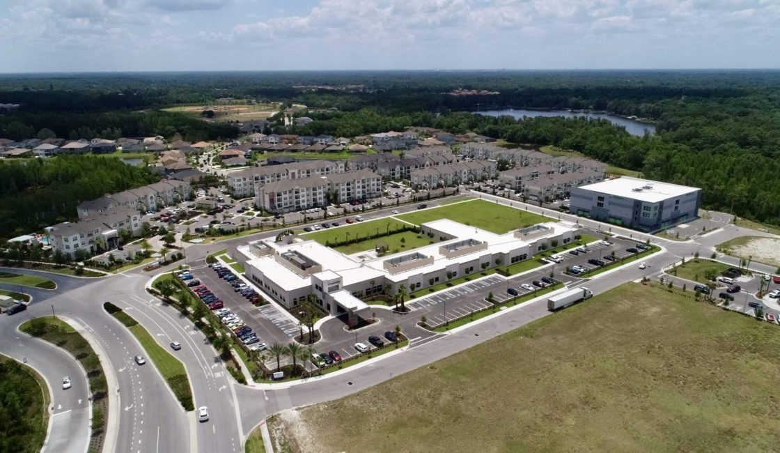 A large white building with grass on top of it.