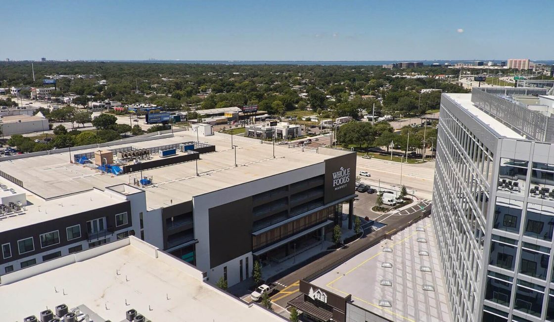 An aerial view of a parking lot with lots of cars parked.