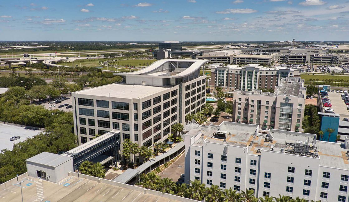 A view of some buildings and trees from above.