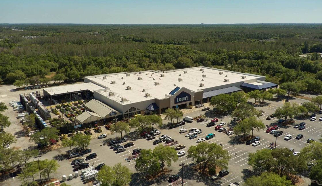 A large shopping center with lots of parking spaces.