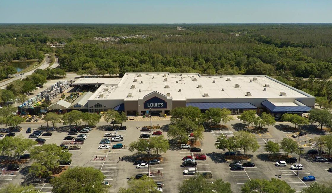 A large parking lot with many cars parked in it.