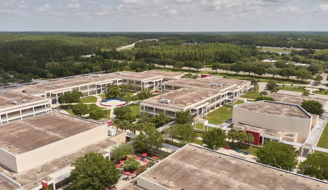 An aerial view of a large campus with lots of trees.