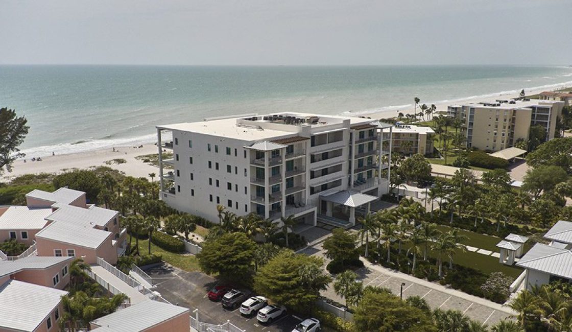 A building with many windows and balconies on top of it.
