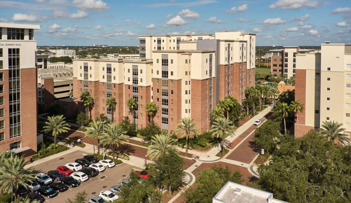 A view of some buildings and cars on the road.