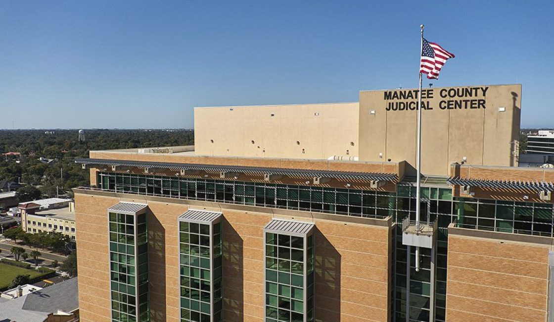 A large building with an american flag on top of it.