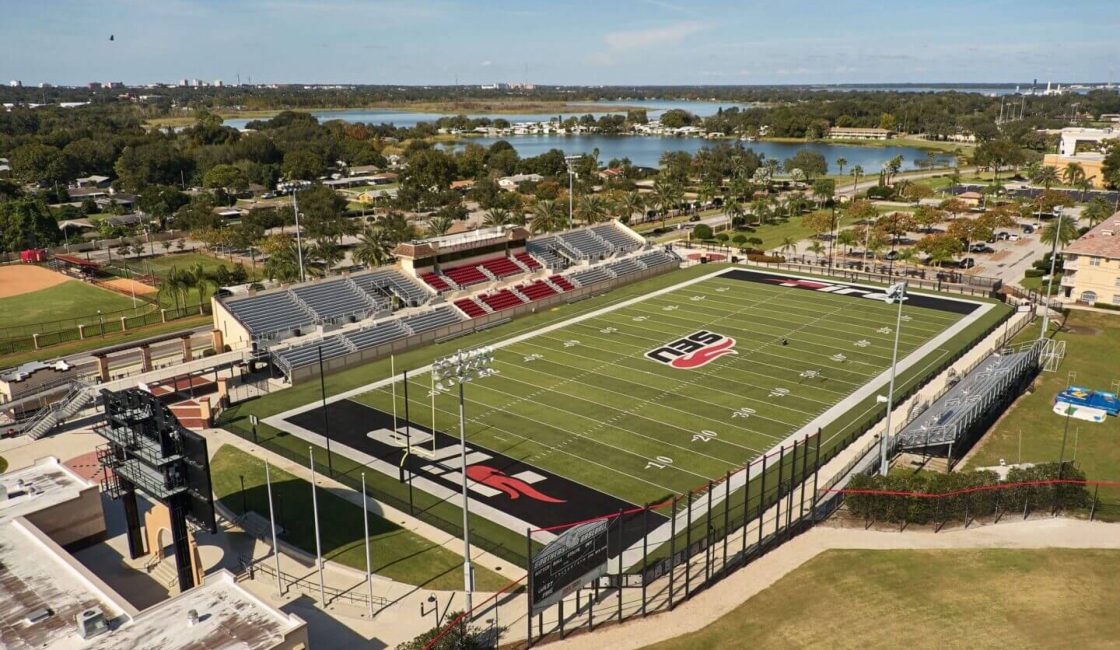 A football field with many fans and a stadium.