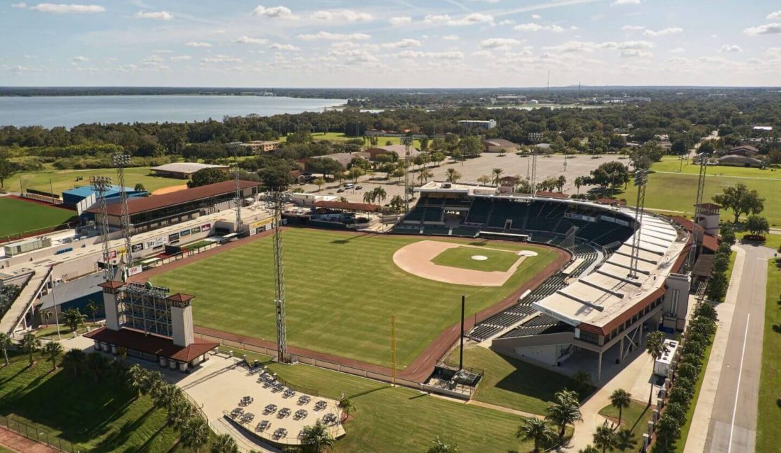A baseball field with a stadium in the middle of it