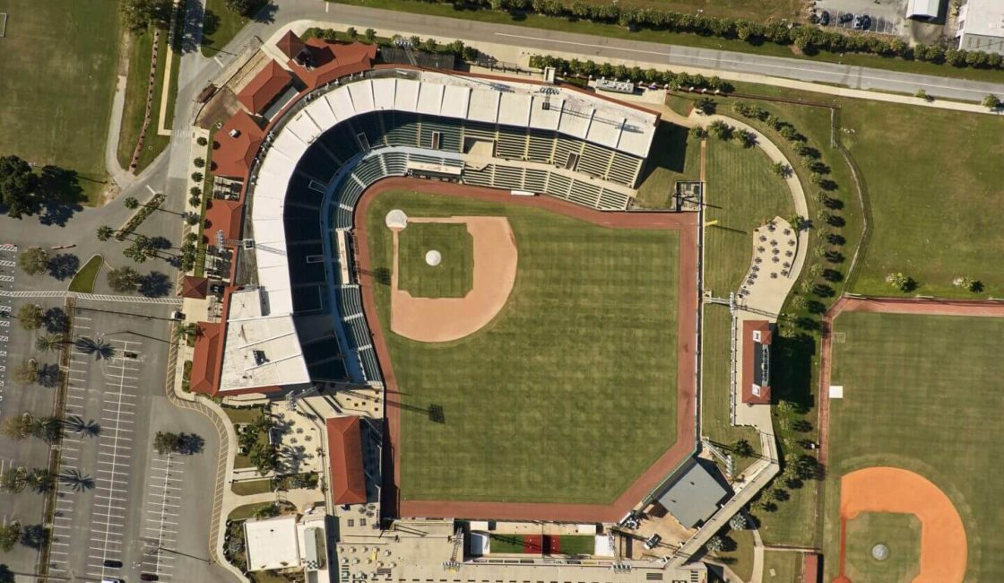 An aerial view of a baseball field with the stadium in the background.