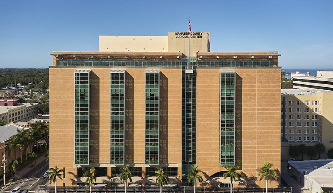 A large building with many windows and trees