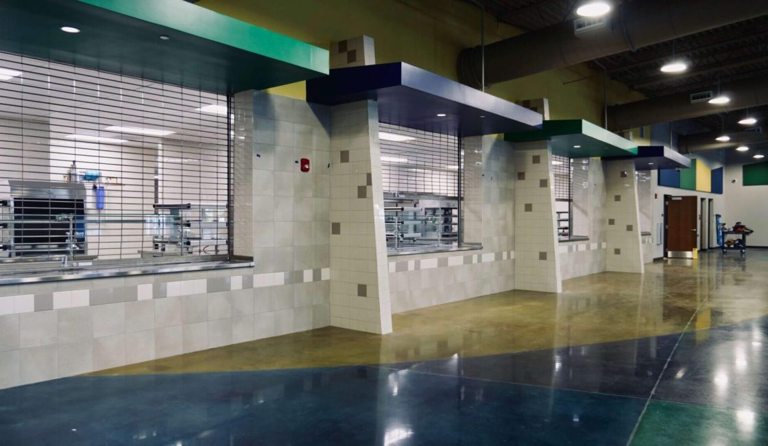 A room with several windows and a tiled floor.