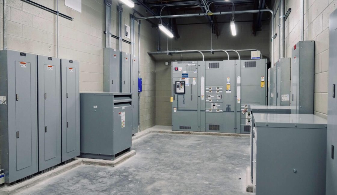 A room with many electrical boxes and cabinets.