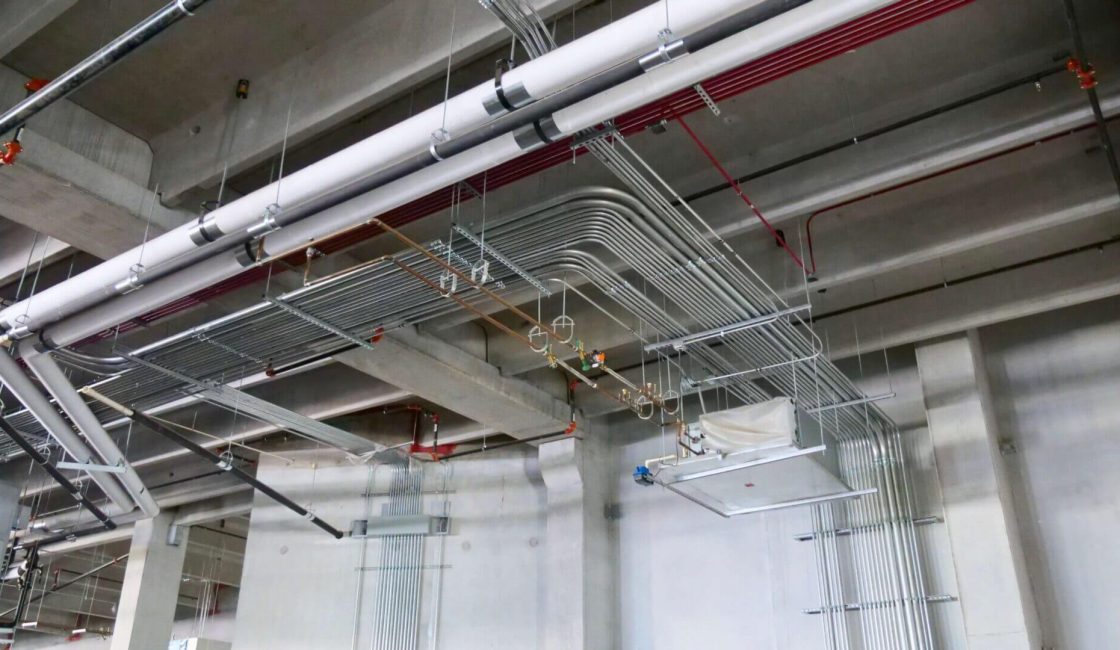 A building with pipes hanging from the ceiling.