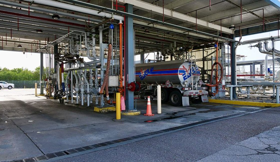 A truck is parked in the middle of an industrial area.