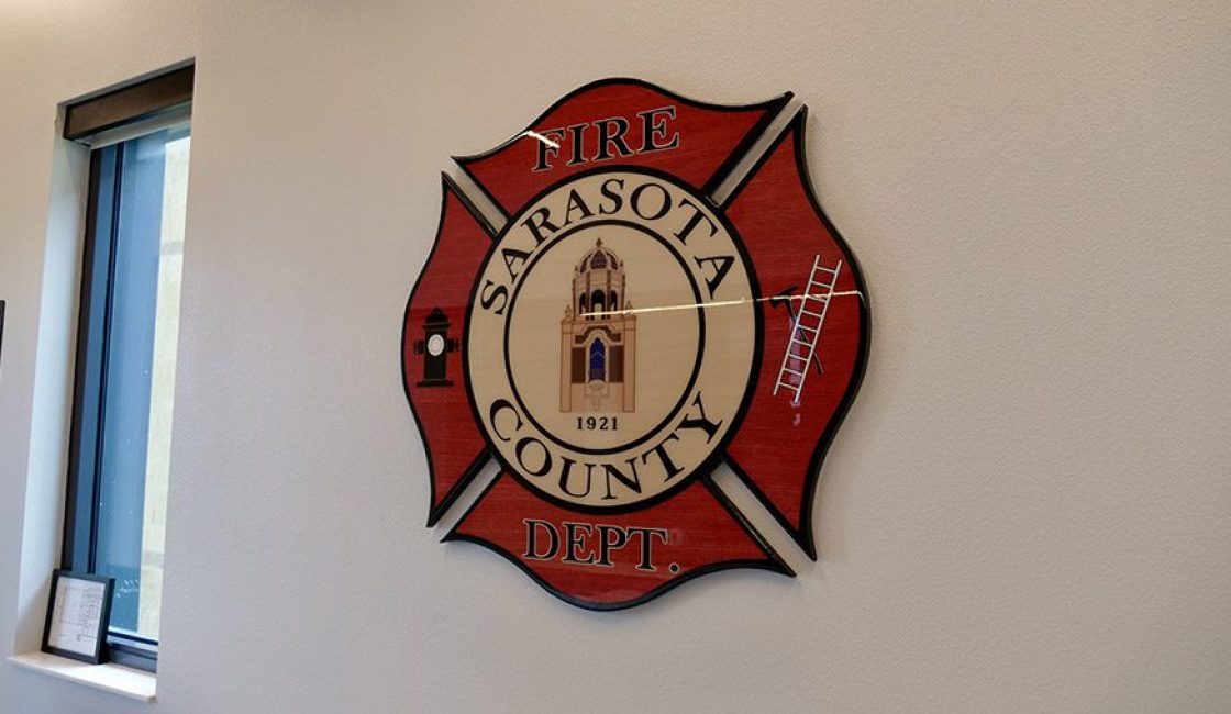 A fire station sign hanging on the wall.