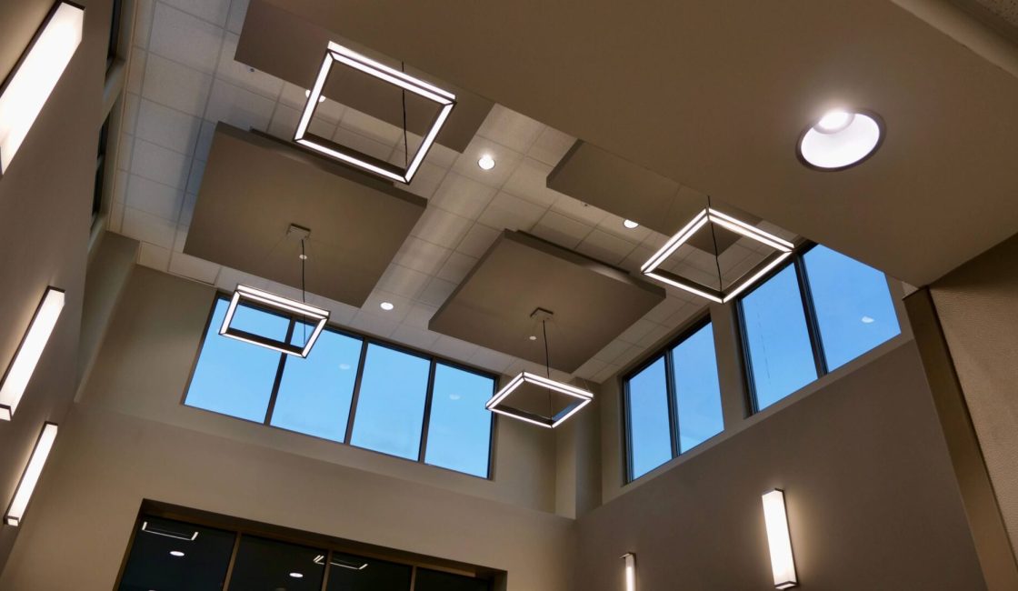 A room with four square lights hanging from the ceiling.