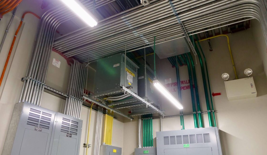 A large room with many pipes and wires.
