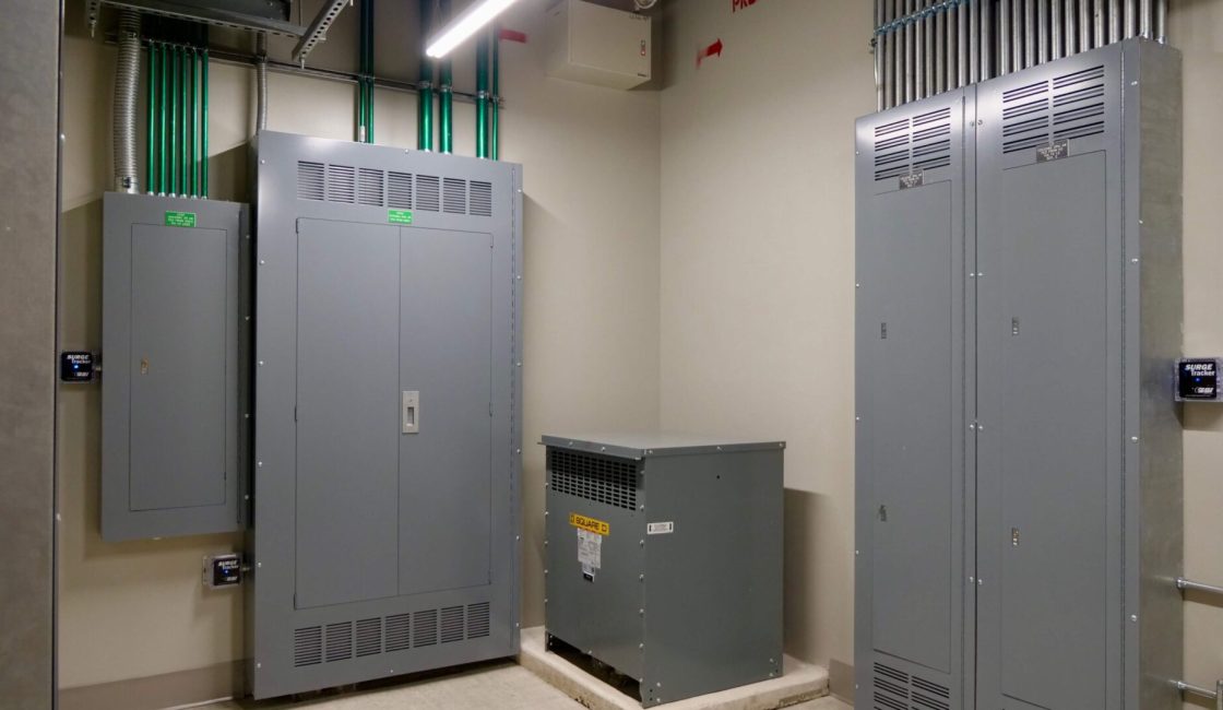 A room with two electrical boxes and one is open