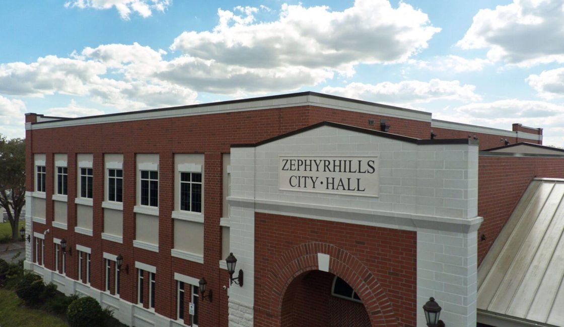 A building with the words zephyr hills city hall on it.
